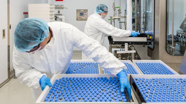 Lab technicians at a Gilead Sciences facility in La Verne, California, load vials of remdesivir. Picture: Gilead Sciences/Reuters