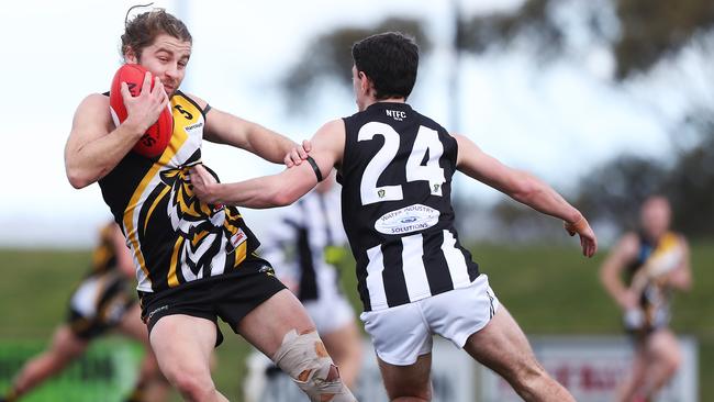 Football. TSL. Tigers V Glenorchy. Tiger Samuel Duigan fends off Luke Nicholson. Picture: Nikki Davis-Jones