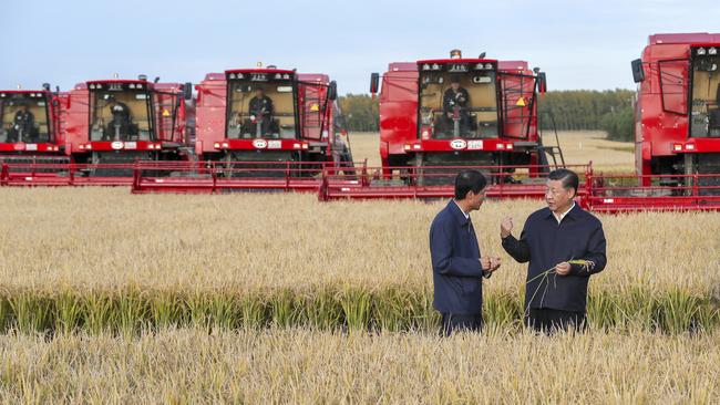 In this Tuesday, Sept. 25, 2018, photo released by China's Xinhua News Agency, Chinese President Xi Jinping, right, visits a farm in Jiansanjiang in northeastern China's Heilongjiang province. Xi was on an inspection tour of the region as China has slapped tariffs on U.S. agricultural imports and looked to increase farming self-sufficiency amid a growing trade war with the United States. (Xie Huanchi/Xinhua via AP)