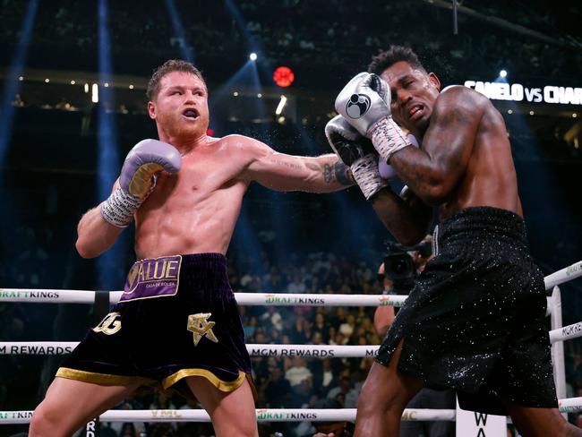 LAS VEGAS, NEVADA - SEPTEMBER 30: Saul "Canelo" Alvarez of Mexico (purple/gold trunks) trades punches withÂ Jermell Charlo (black trunks)Â during theirÂ super middleweight title fight at T-Mobile Arena on September 30, 2023 in Las Vegas, Nevada.   Sarah Stier/Getty Images/AFP (Photo by Sarah Stier / GETTY IMAGES NORTH AMERICA / Getty Images via AFP)