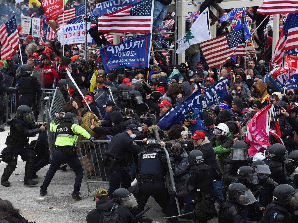 Trump supporters clash with police and security forces as they push barricades to storm the US Capitol in Washington D.C. Picture: AFP