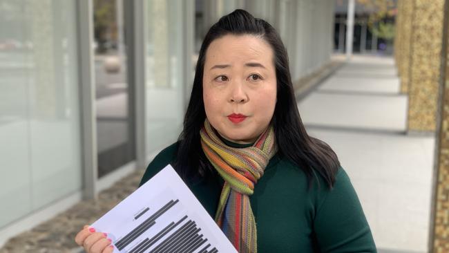 Elizabeth Lee holds up a heavily redacted document from CIT on June 7, 2022. Picture: Julia Kanapathippillai