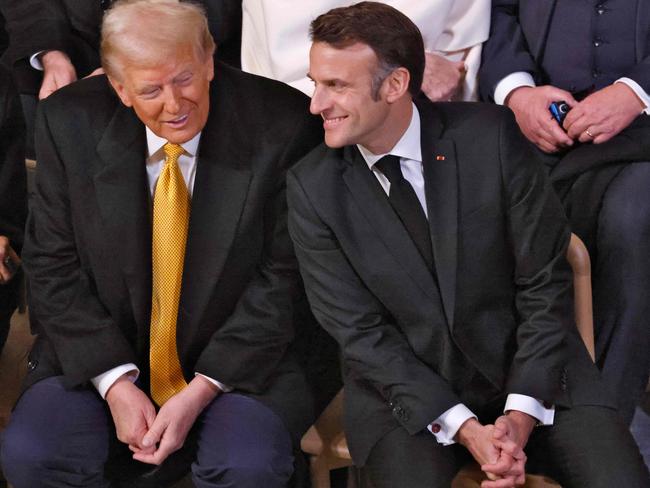 Mr Trump and Mr Macron looked relaxed ahead of the ceremony inside Notre Dame Cathedral. Picture: AFP