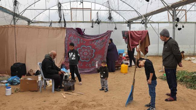 alestinians, displaced by the Israeli bombardment of Khan Yunis, seek shelter inside an agricultural tent in Rafah in the southern Gaza Strip on December 21, 2023. Picture: Mohammed Abed/AFP