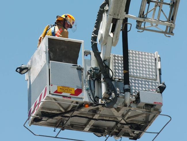 False fire alarm on roof of KPMG office building on the corner Pulteney and Pirie Street, Hindmarsh Square in Adelaide - Firefighters using crane to access roof of building.