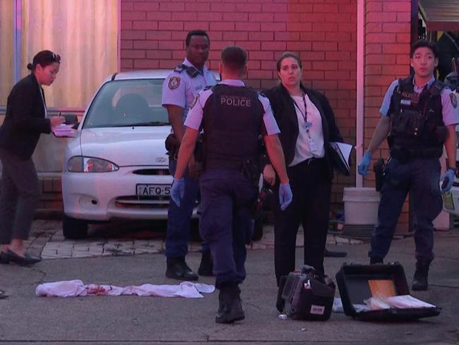 Police at the scene, and a bloodstained towel. Picture: TNV