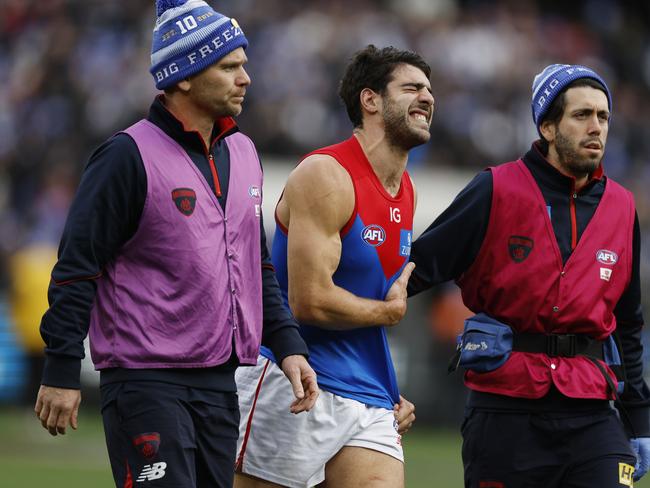 Christian Petracca of the Demons in pain after copping a Darcy Moore knee in the ribs late in the first quarter. Picture: Michael Klein