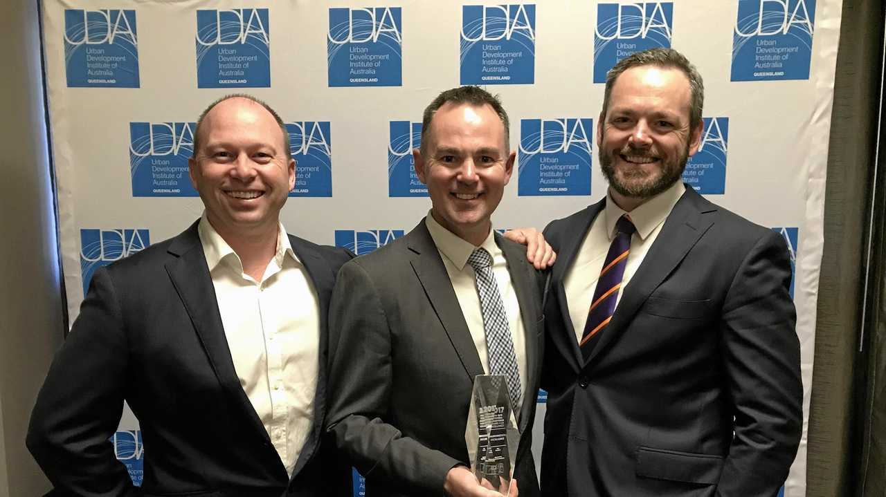 Stockland&#39;s Adrian Allen, left, with Mark Stephens and Ben Simpson with the UDIA Qld Environmental Excellence Award.