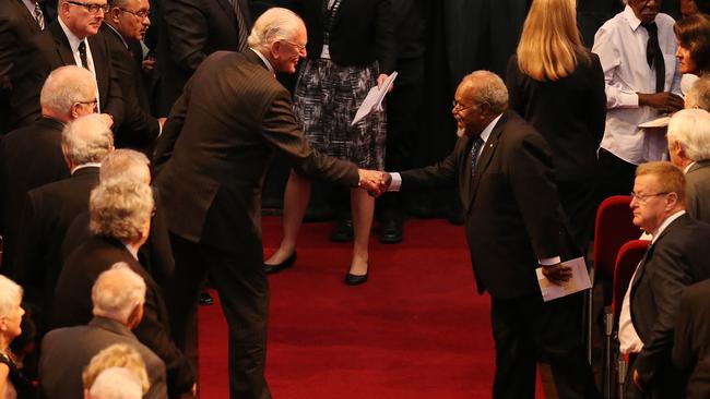 Malcolm Fraser and Michael Somare shake hands at Gough Whitlam’s funeral in 2014. Picture: John Feder