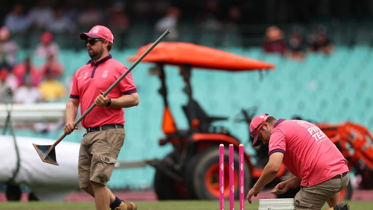 Ground staff work to prepare the field during day four. Picture: Getty