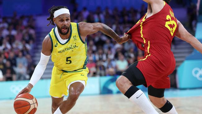 Australia's #05 Patty Mills works around Spain's #23 Sergio Llull in the men's preliminary round group A basketball match between Australia and Spain during the Paris 2024 Olympic Games at the Pierre-Mauroy stadium in Villeneuve-d'Ascq, northern France, on July 27, 2024. (Photo by Thomas COEX / AFP)