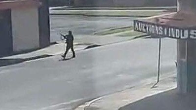 An active gunman is seen firing shots on a busy street in Windang, near Wollongong, this morning. Supplied