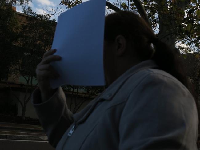 Smith covered her face to prevent being photographed leaving court.