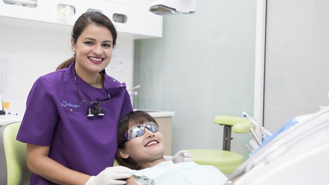 Sonia Sonia of Kallangur Dental with a patient. The business won the Customer Service Excellence Award and Business of the Year. Photo: Dominika Lis