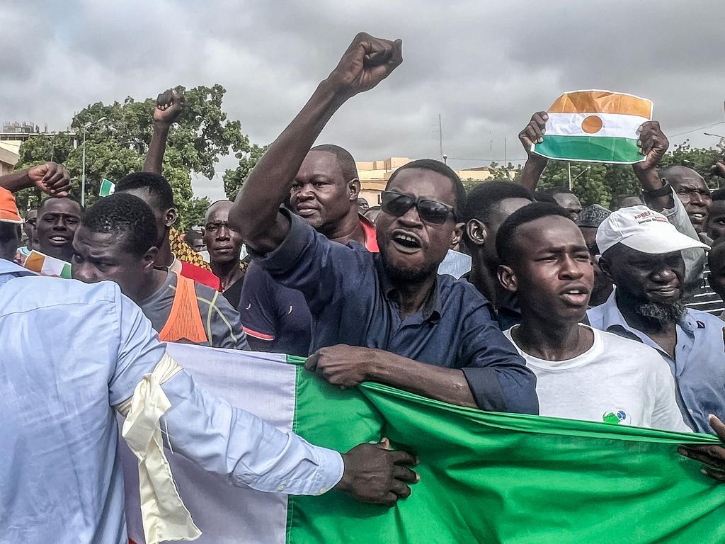 Protesters gesture during a demonstration on independence day in Niamey on August 3, 2023.