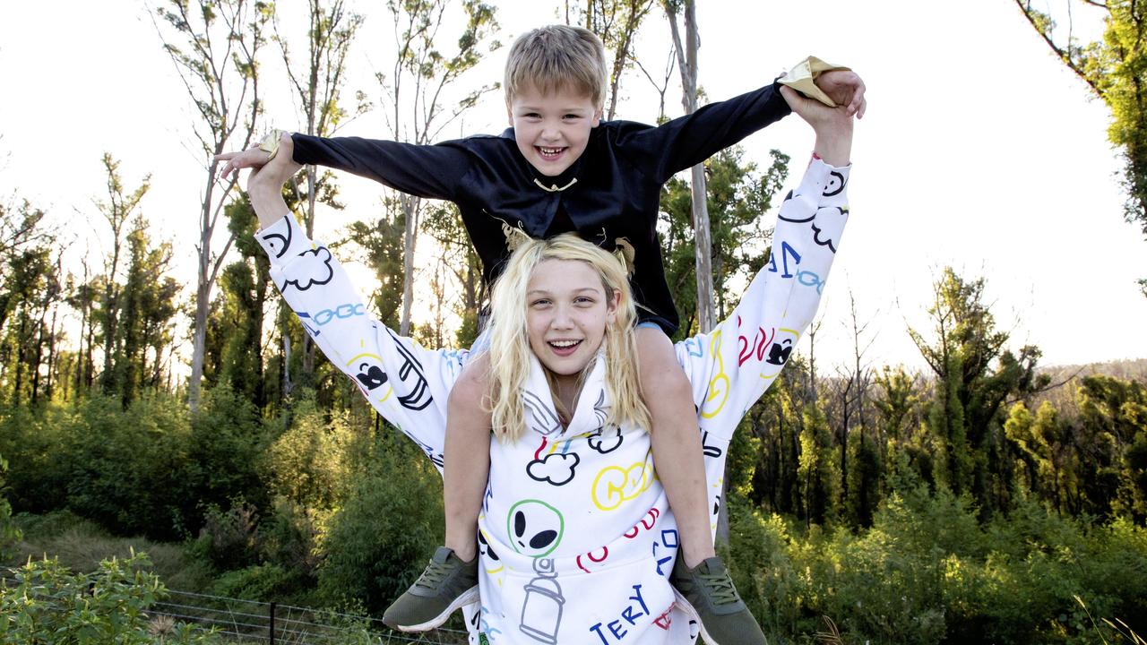 Reekid with one of his siblings at his family property, which is surrounded by bushland that was devastated in the Black Saturday bushfires.