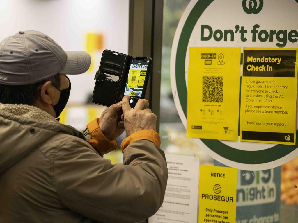 A person scans a QR code before entering a supermarket in Victoria. Picture: NCA NewsWire/Daniel Pockett