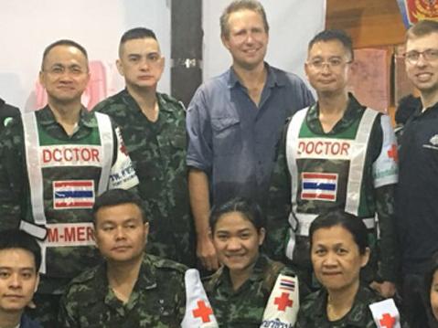 A supplied image obtained on Wednesday, July 11, 2018, of Australian doctor Richard Harris (centre),  and the medical team he worked with to assist in the rescue of 12 Thai boys who were stuck in an underground cave with their soccer coach, but have since been rescued. (AAP Image/Supplied by DFAT) NO ARCHIVING