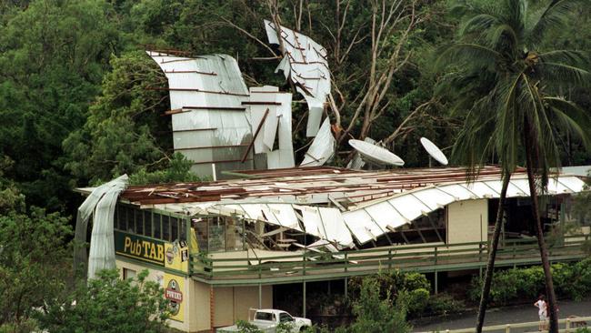 The corrugated iron roof of Cairns Trinity Beach Hotel lies against surrounding trees after area was hit by Cyclone Steve in 2000. Picture: Steve Brennan