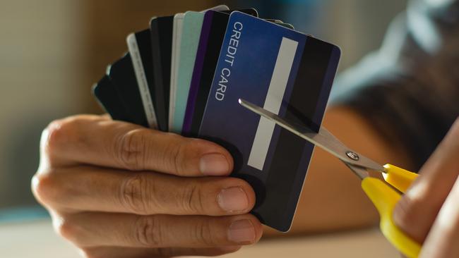 Young man cutting credit card with scissors,Man is destroying credit cards because of big debt.