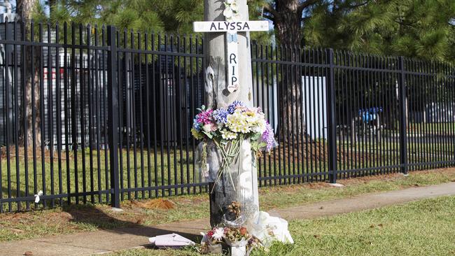 The crash site, which is now home to a memorial of Alyssa Postle, at the intersection of Lavarack and Old North roads, Brendale. Around 1am one morning, not long after Alyssa’s tragic death, the father of one of Alyssa’s friends drove to the site to install the handmade cross. He is one of a host of people who have supported the Postle family since the tragic event. Picture: Attila Csaszar