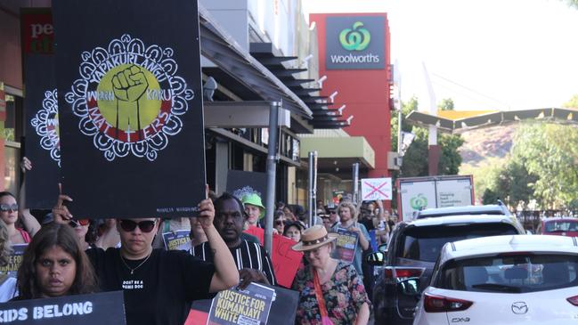 Marchers head down Hartley St, Alice Springs, once the courthouse lawns rally concluded. Picture: Gera Kazakov