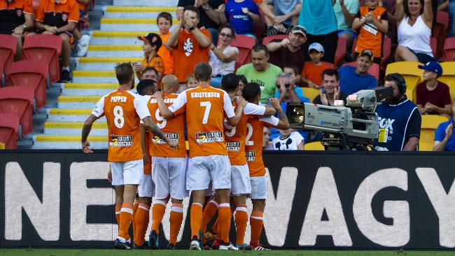 Roar players celebrate a goal against the Central Coast Mariners.