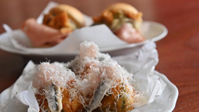 Mozzarella fritters, sour onions and white anchovy with (behind) mortadella bun with pork crackling and sweet pickle. Picture: Keryn Stevens