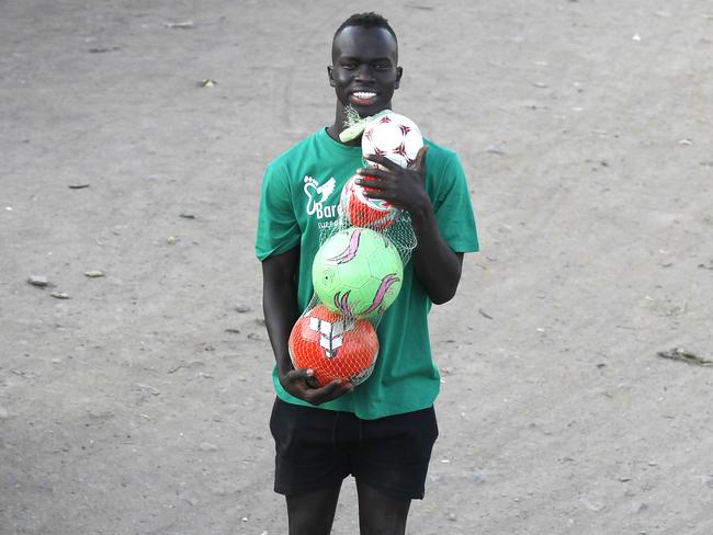 TWAM-20180818        EMBARGO FOR TWAM 18 Aug 2018  NO REUSE WITHOUT PERMISSION FEE APPLIESIan Smith refugee camp at Kakuma. Awer Mabil with footballs ahead of a soccer gamePic : Njeri Mwangi