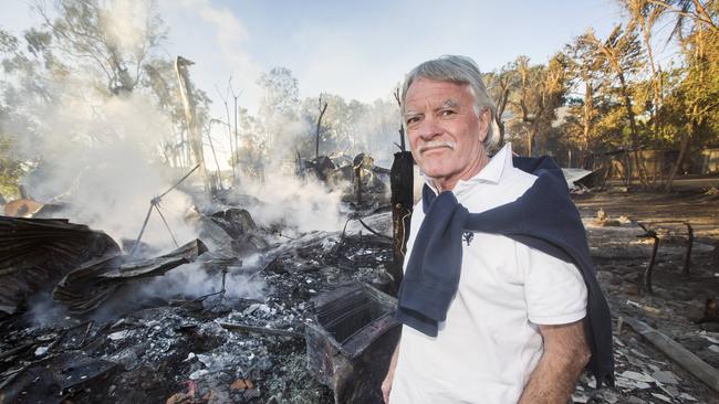 Michael Hancock stands in the ashes of his house at 65 Noosa River Road on Noosa North Shore. Picture: Lachie Millard