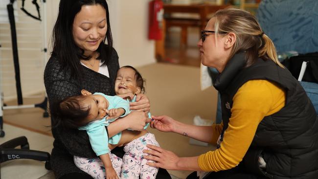 Travelling nurse Tshewang Choden with Nima and Dawa before they were separated. Picture: Alex Coppel