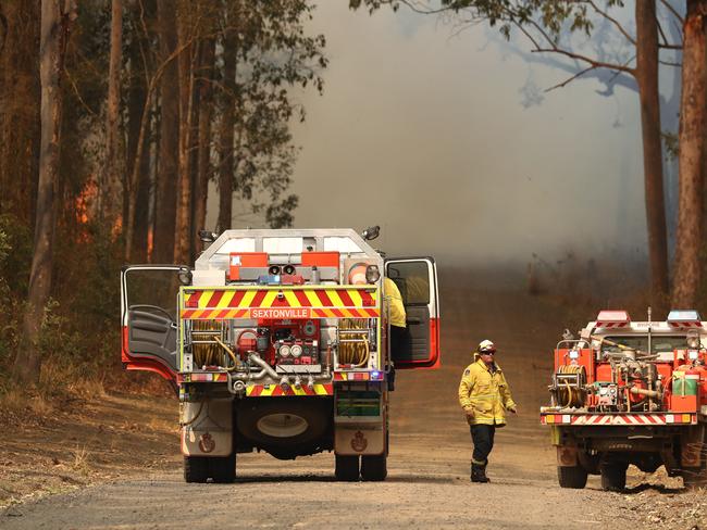 Firefighters battle bushfires in Busbys Flat, northern NSW, Wednesday, October 9, 2019. (AAP Image/Jason O'Brien)