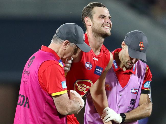 ADELAIDE, AUSTRALIA - APRIL 02: Jarrod Witts of the Suns down with a knee injury during the 2021 AFL Round 03 match between the Adelaide Crows and the Gold Coast Suns at Adelaide Oval on April 02, 2021 in Adelaide, Australia. (Photo by Sarah Reed/AFL Photos via Getty Images)