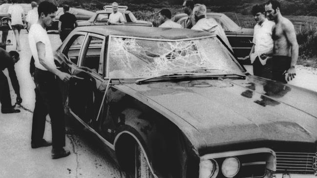 Curious onlookers inspect Senator Edward (Ted) Kennedy's car. Mary Jo Kopechne was killed after Kennedy drove the car off Dyke Bridge on Chappaquiddick Island, Massachussetts.