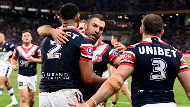 James Tedesco celebrates with Daniel Tupou. Picture: Bradley Kanaris/Getty Images