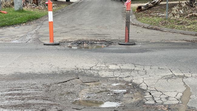 Fresh potholes that sink deeper when driven over have appeared in Coburn Ave above the McCrae landslide hot zone. Picture: Lucy Callander