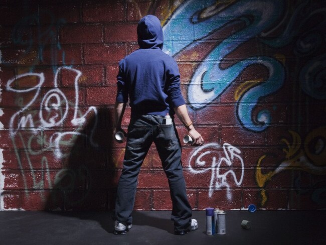 Teenager with cans of spray paint