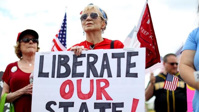 A protester participates in a Reopen Massachusetts Rally near Governor Charlie Baker’s residence. Picture; AFP.