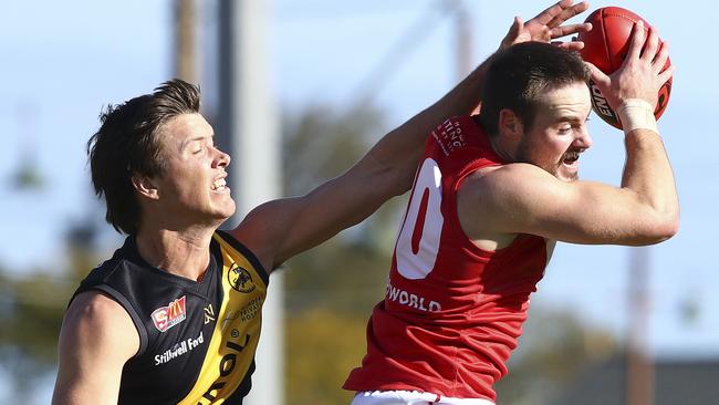 North Adelaide’s Max Thring marks ahead of Glenelg’s Ziggy Vitkunas. Picture: SARAH REED