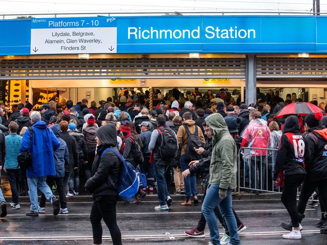 Football fans enter Richmond Station after the big Anzac Day match at the MCG, on Saturday 25th April, 2015. Picture: Mark Dadswell