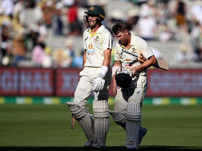 Australia's Marnus Labuschagne (L) and David Warner (R) walk off at the end of play during the first day of the second cricket Test match between Australia and South Africa at the MCG in Melbourne on December 26, 2022. (Photo by William WEST / AFP) / - IMAGE RESTRICTED TO EDITORIAL USE - STRICTLY NO COMMERCIAL USE-