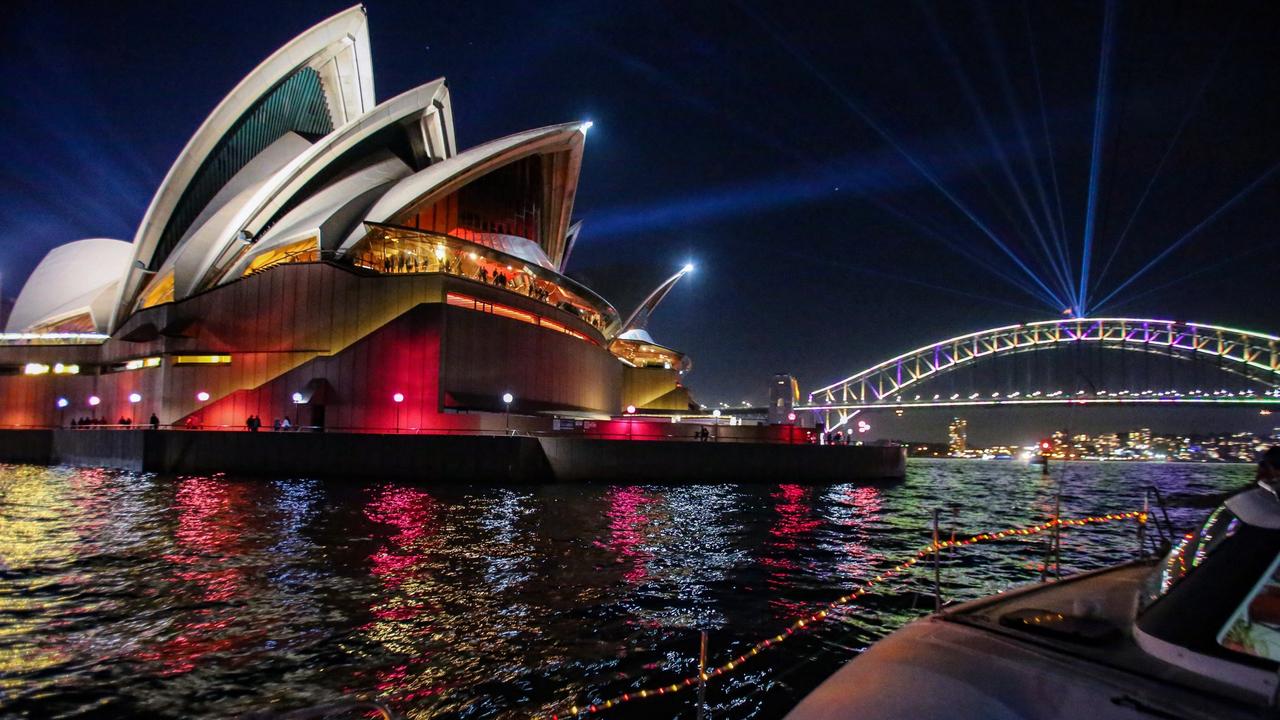 The Sydney Harbour Bridge and Opera House are pictured at night from the One Ocean Sailing catamaran. Picture: Nicholas Eagar