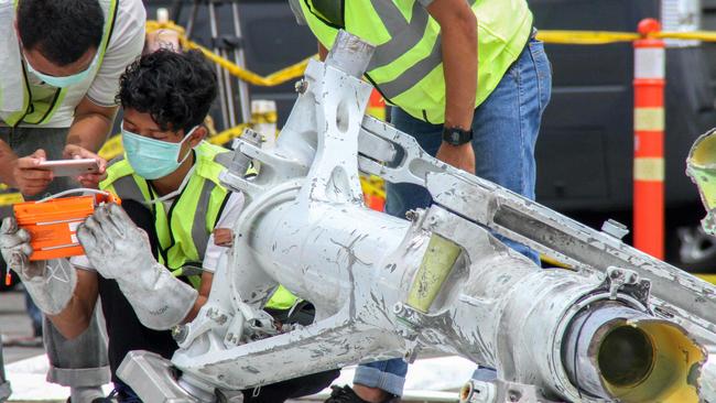 Lion Air investigators examine part of the landing gear of the ill-fated Lion Air flight.