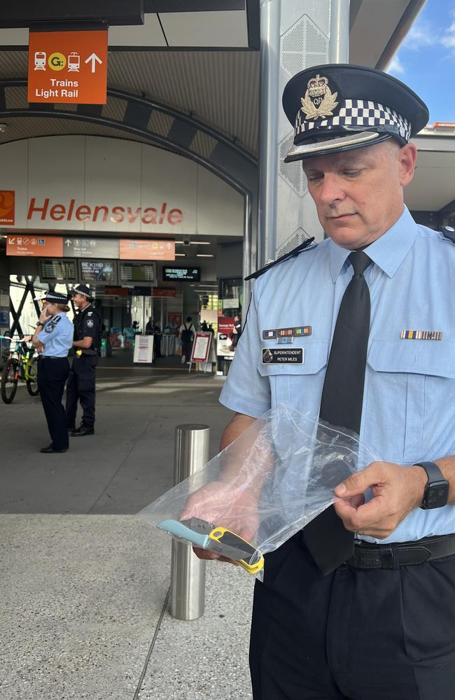 Superintendent Peter Miles with knives seized by police at Helensvale Train Station on Wednesday.