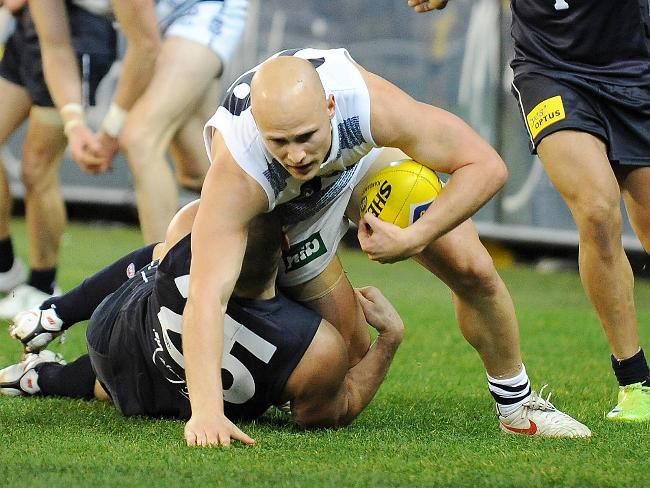 Carlton v Geelong. MCG. Gary Ablett Jr tackled by Brendan Fevola in the second half. Ablett tapped Fevola on his head afterwards. Picture: George Salpigtidis
