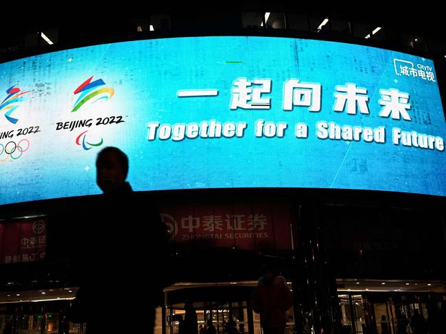 An outdoor screen shows the slogan for Beijing 2022 Winter Olympics and Paralympic Games. Picture: AFP