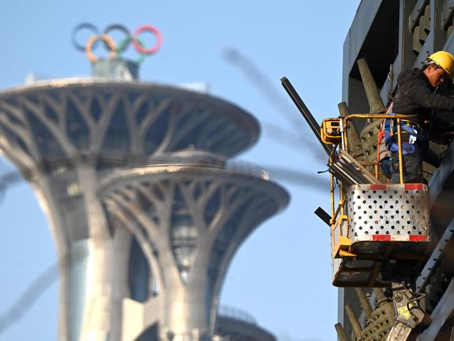 A man works near the Beijing Olympic Tower in Beijing, host to the 2022 Winter Olympic Games. Picture: AFP