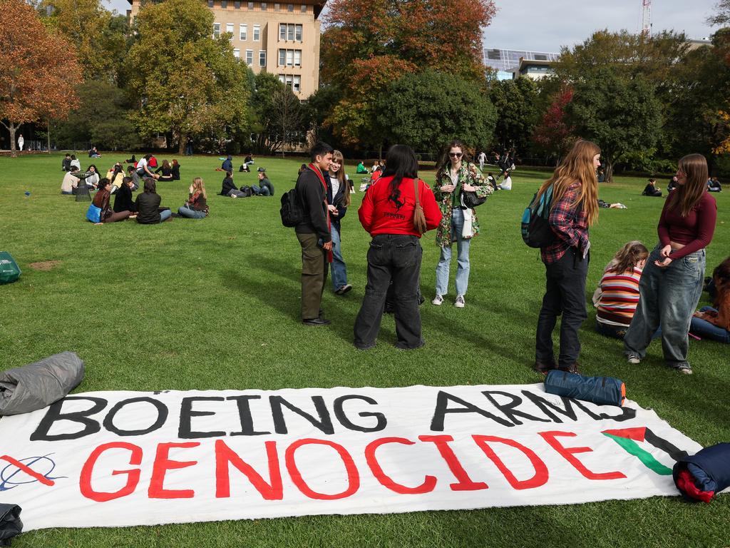 Students gather with signs on the lawn at University of Melbourne. Picture: Jason Edwards
