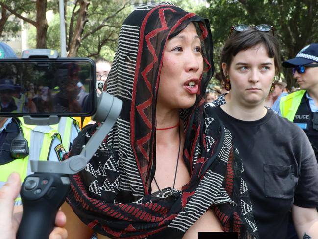 ONE TIME WEB USE ONLY - FEE APPLIES FOR REUSE -  Mandatory Credit: Photo by Richard Milnes/Shutterstock (10539433g)Police escort away a naked female protester'Invasion Day' march, Sydney, Australia - 26 Jan 2020  Picture: Richard Milnes/Shutterstock