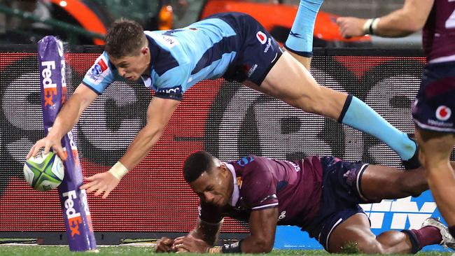 Alex Newsome scores for the Waratahs against the Reds last week. An Origin-style fixture may flop but is worth a try. Picture: AFP